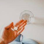 person holding white medication pill